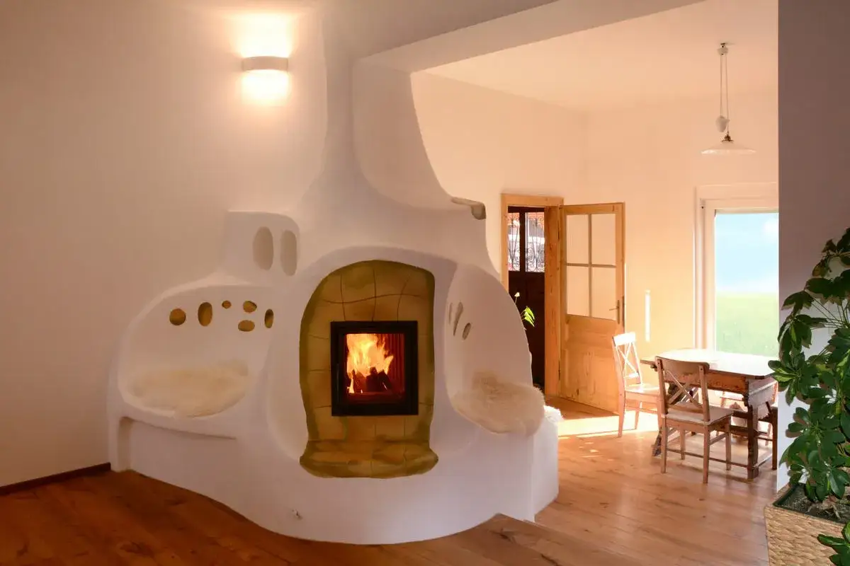 Chimeneas modernas de obra con un diseño orgánico y acogedor, integrando asientos y un espacio para la leña.